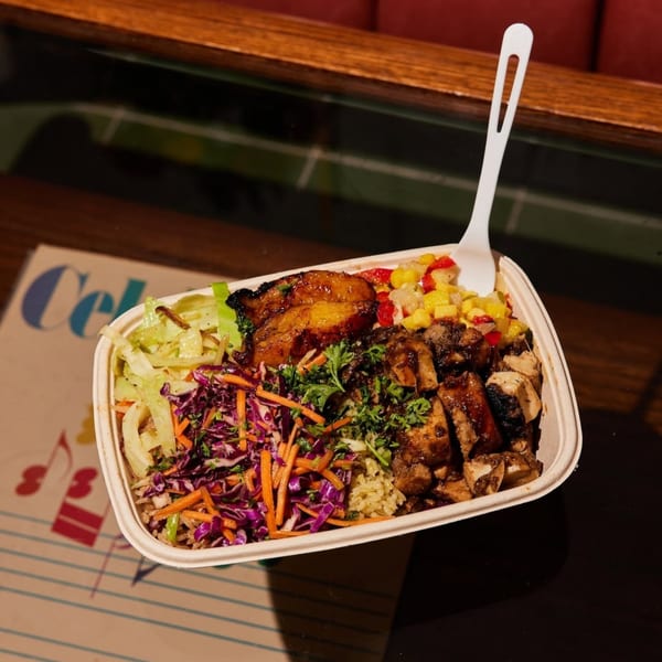 A Jrk! Jamaican jerk chicken bowl with plantains, corn salsa, and coleslaw.